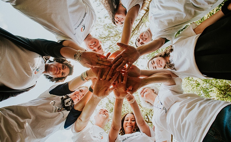 group of people sitting on the ground practicing yoga.