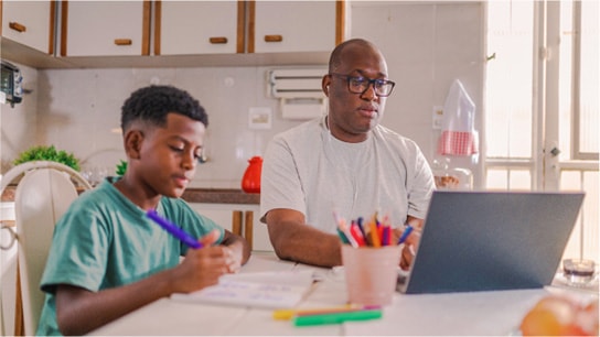 Three people review Cisco U. plans displayed on a monitor