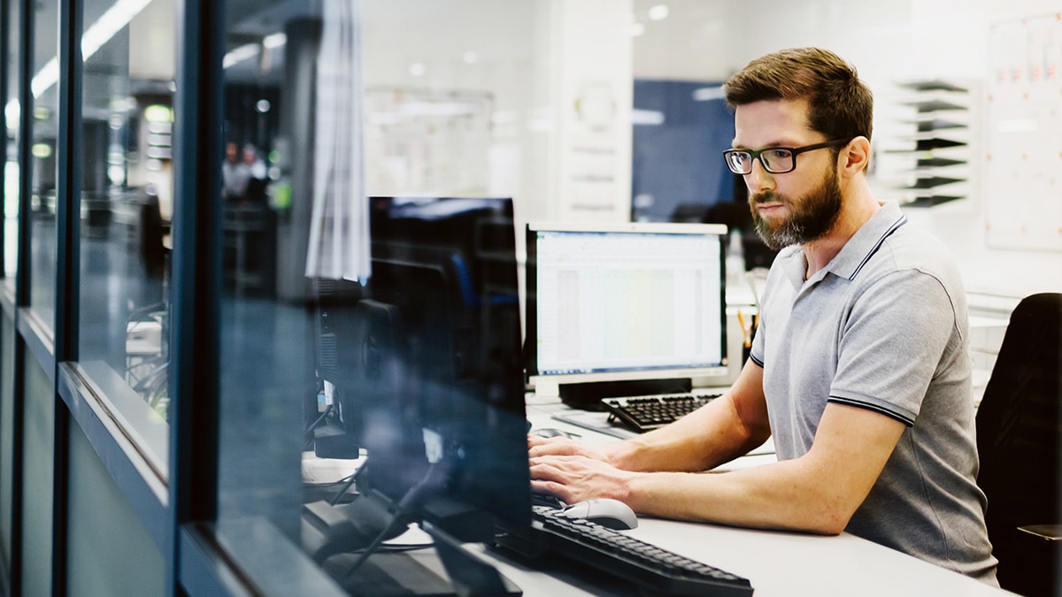 Worker on laptop in office environment